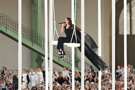 Riley Keough Performs on a Swing at Paris Fashion Show .